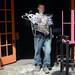 Bob Bianchi carries an arm load of hangers to the trash container as he works with a contractor to clear out the contents of the former Dream Nite Club on Monday morning.  Melanie Maxwell I AnnArbor.com